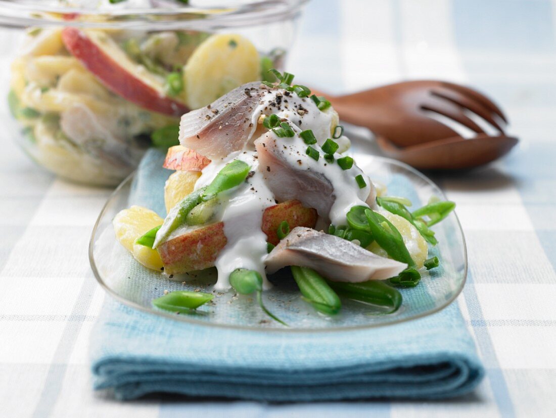 Potato and bean salad with soused herring strips and apple