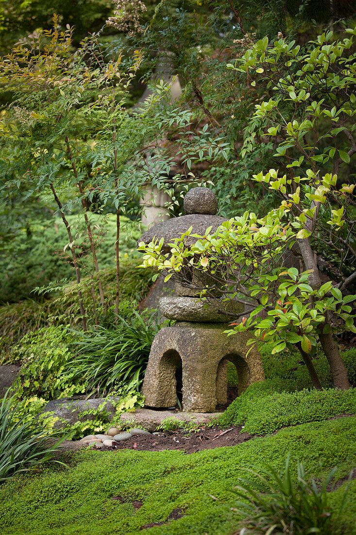Oriental stone Tōrō lantern in garden