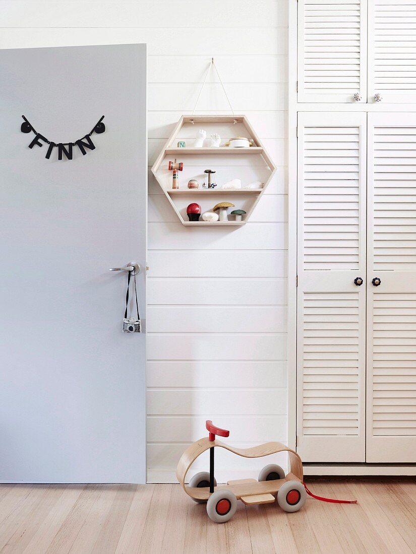 Children's room with name on room door, built-in closet and wall shelf