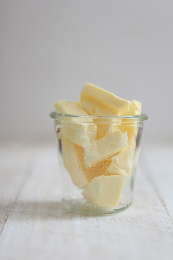 Chunks of butter in a glass jar