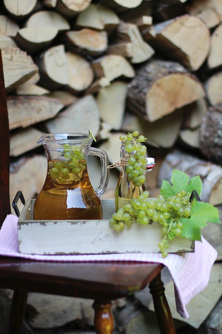 Reproduced in a jar and a flip-top glass bottle on a tray outdoors