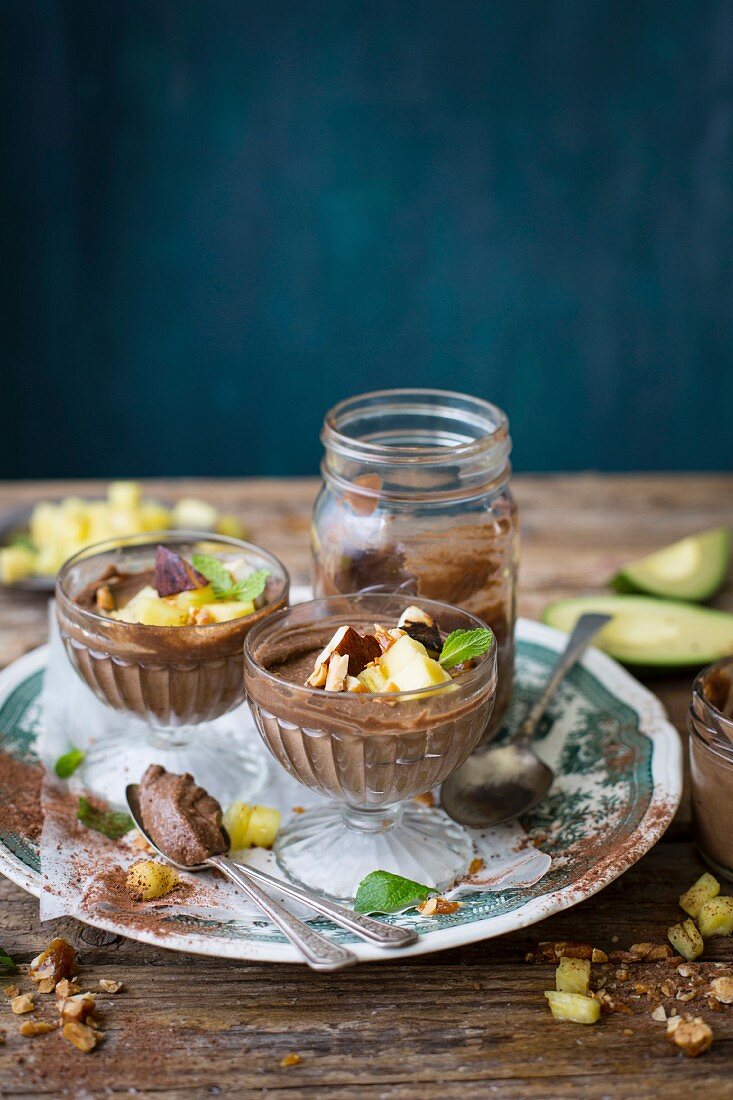 Raw avocado chocolate pudding with coconut, cashews, and pineapple and mint salsa