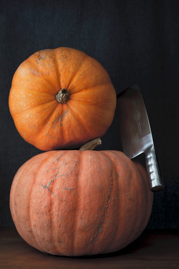 Two pumpkins with a cleaver
