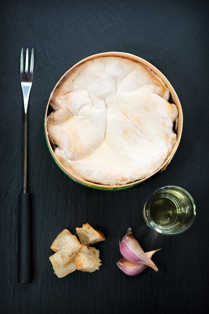 Baked Mont d'Or cheese with white wine, onion and chunks of bread