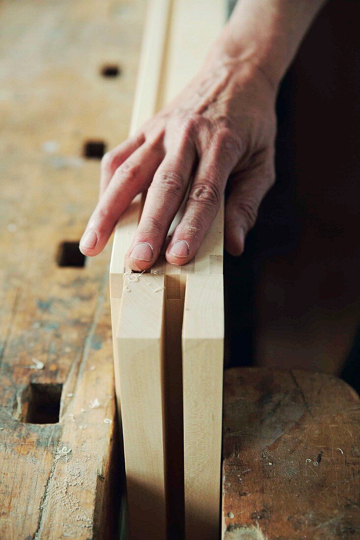 Wood being sanded with sanding paper