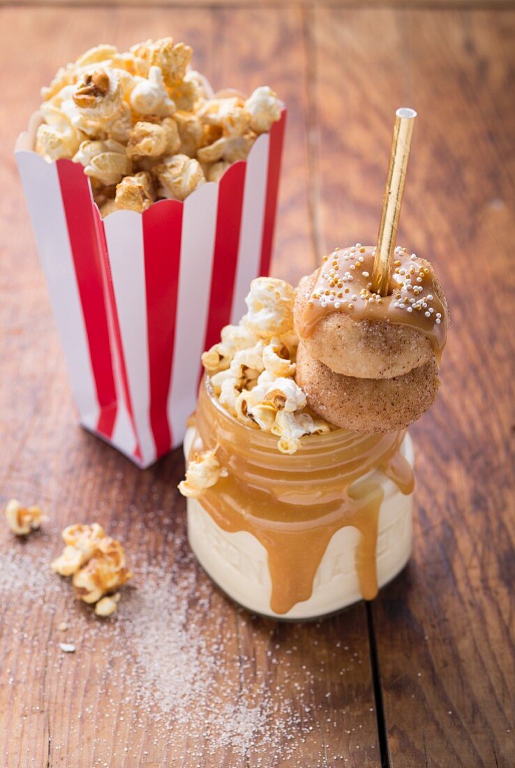 A freak shake with mini doughnuts, popcorn and caramel sauce