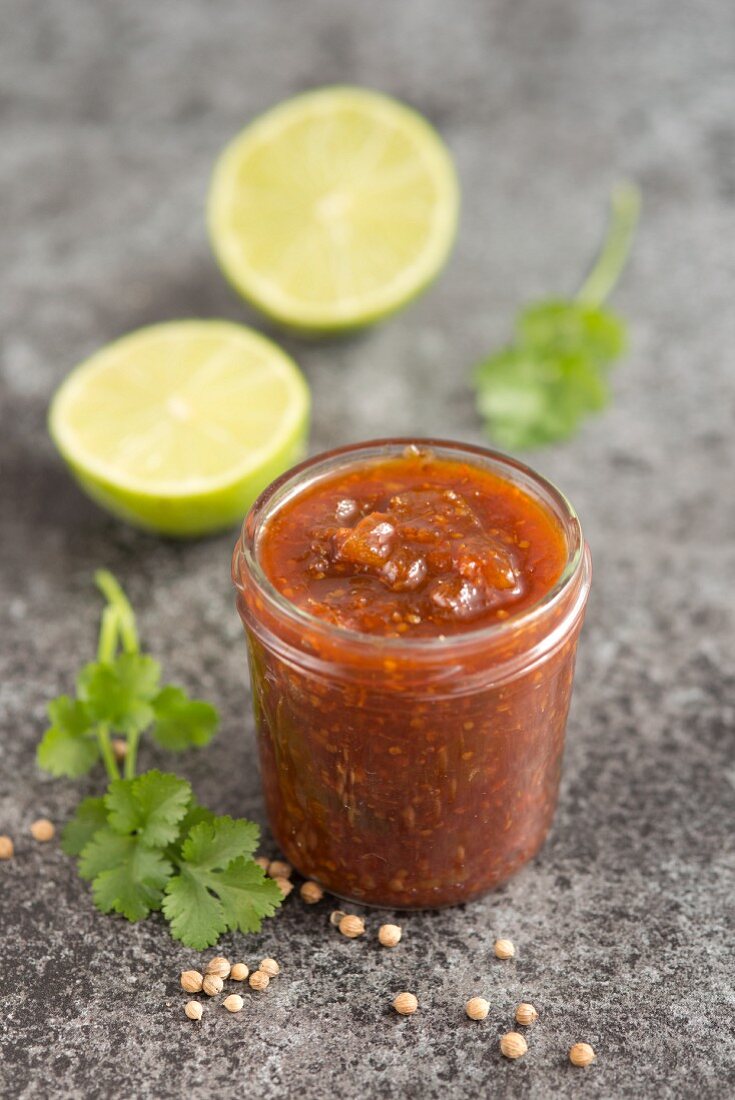 Lime, mango, chilli and coriander chutney in a glass jar