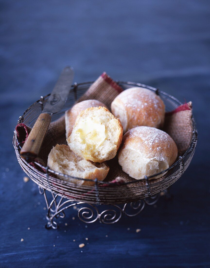 Bread rolls with butter in a bread basket