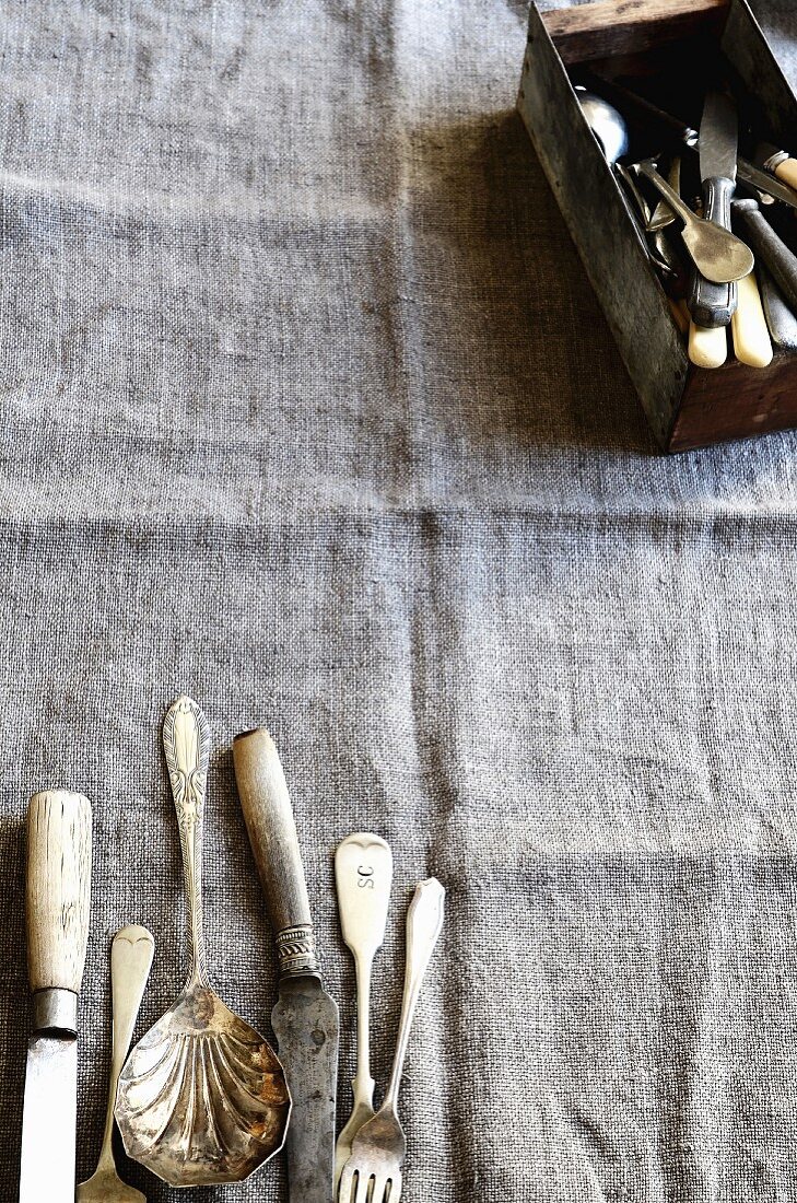 Antique cutlery on a fabric surface