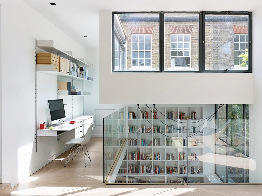 Bright workspace on gallery with modern glass balustrade