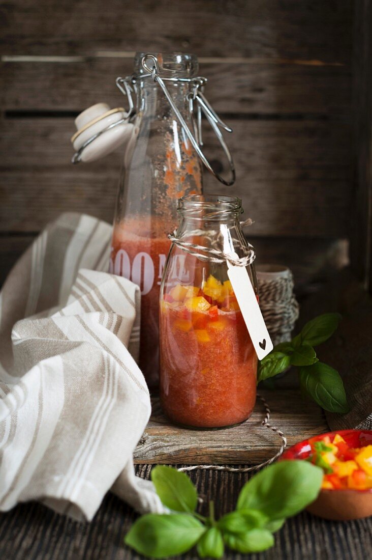 Gazpacho with tomato and peppers in swing-top bottles