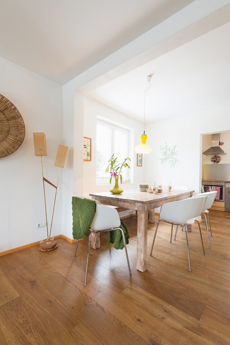 Wooden table and white shell chairs