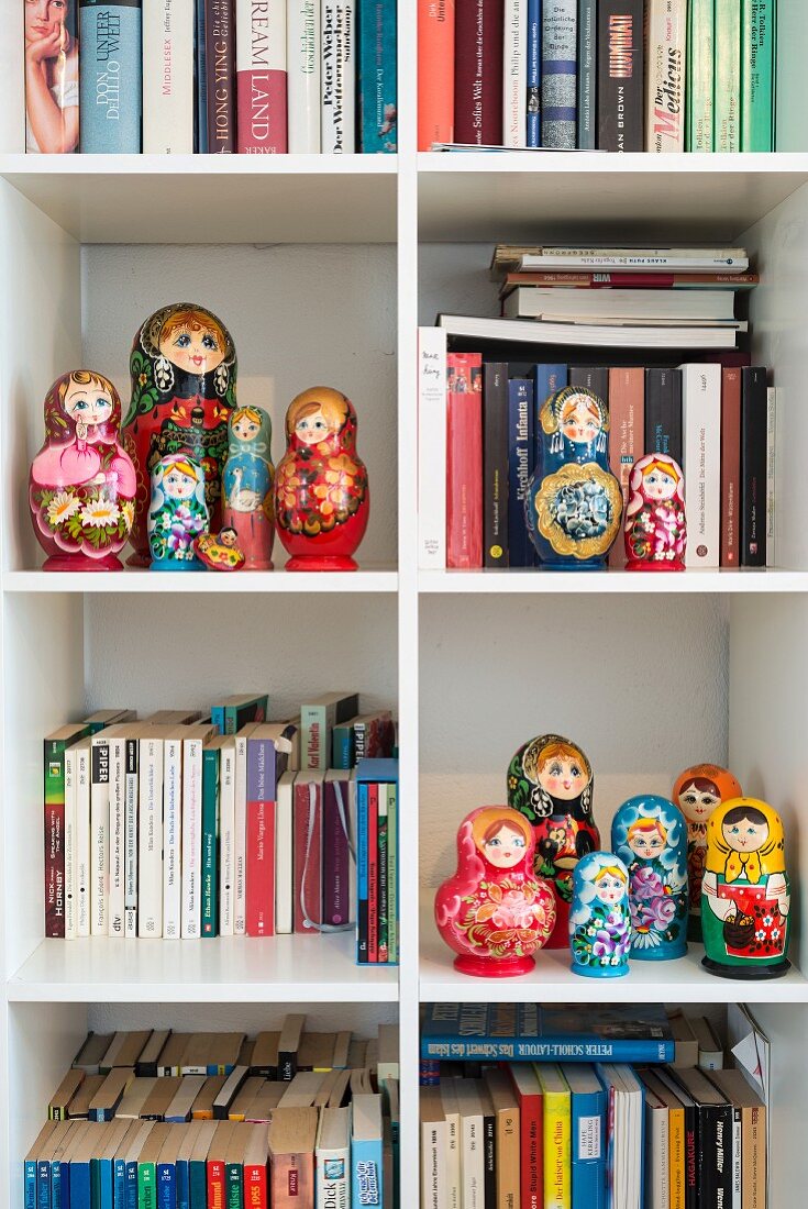 Collection of Russian dolls on bookshelves