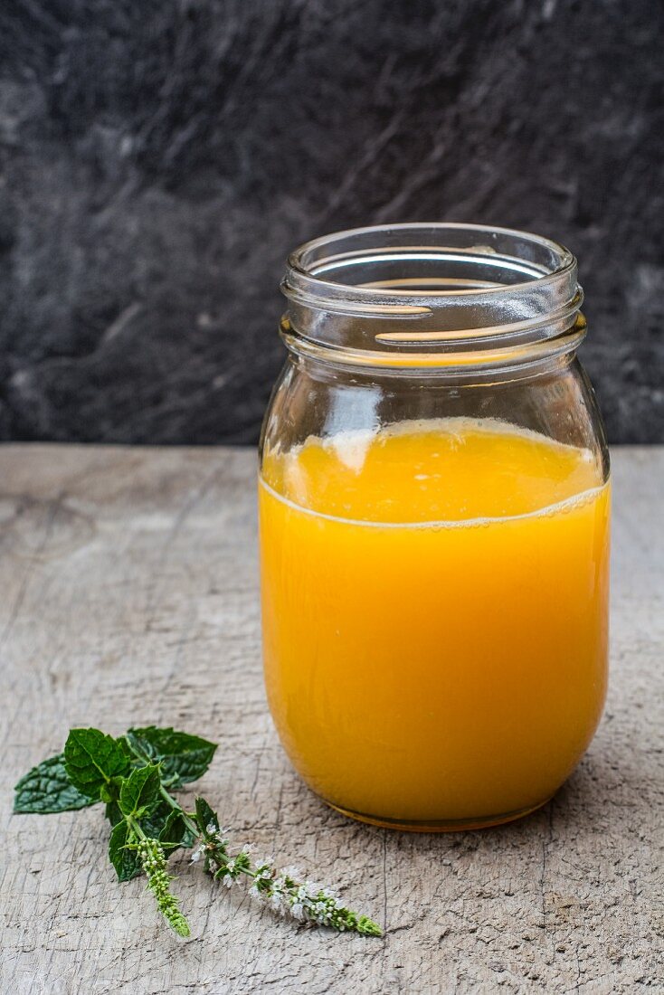 Orange juice in a screw-top glass jar