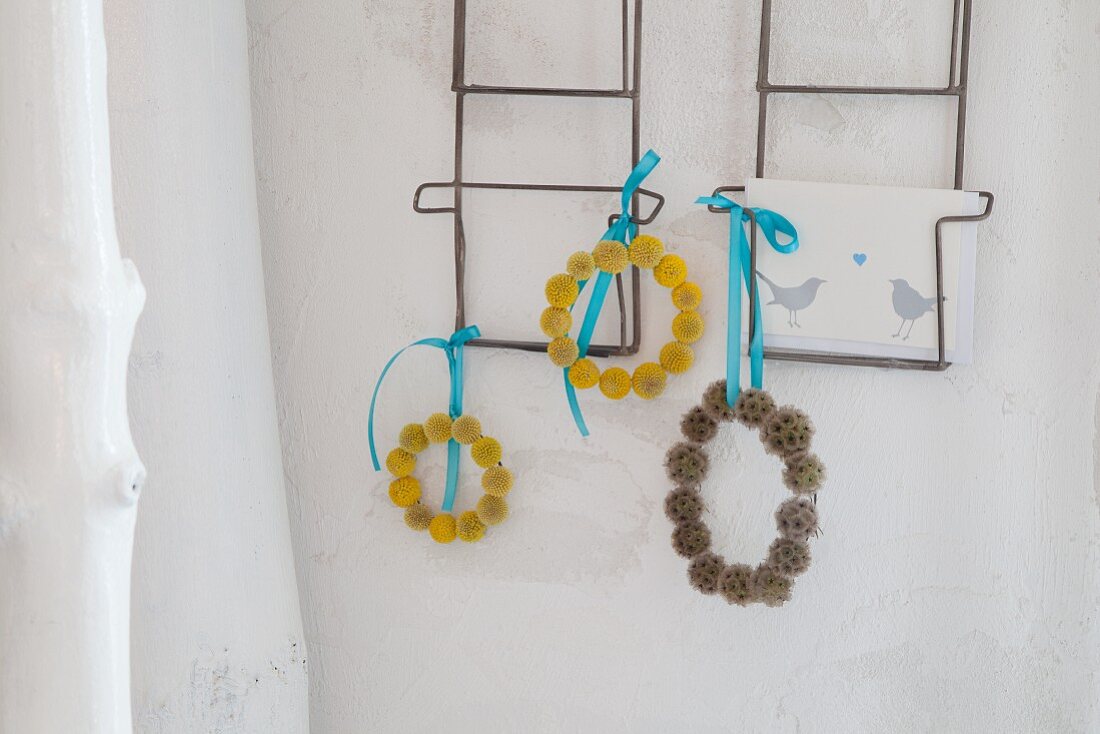 Wreaths of Craspedia and scabious hung form postcard rack