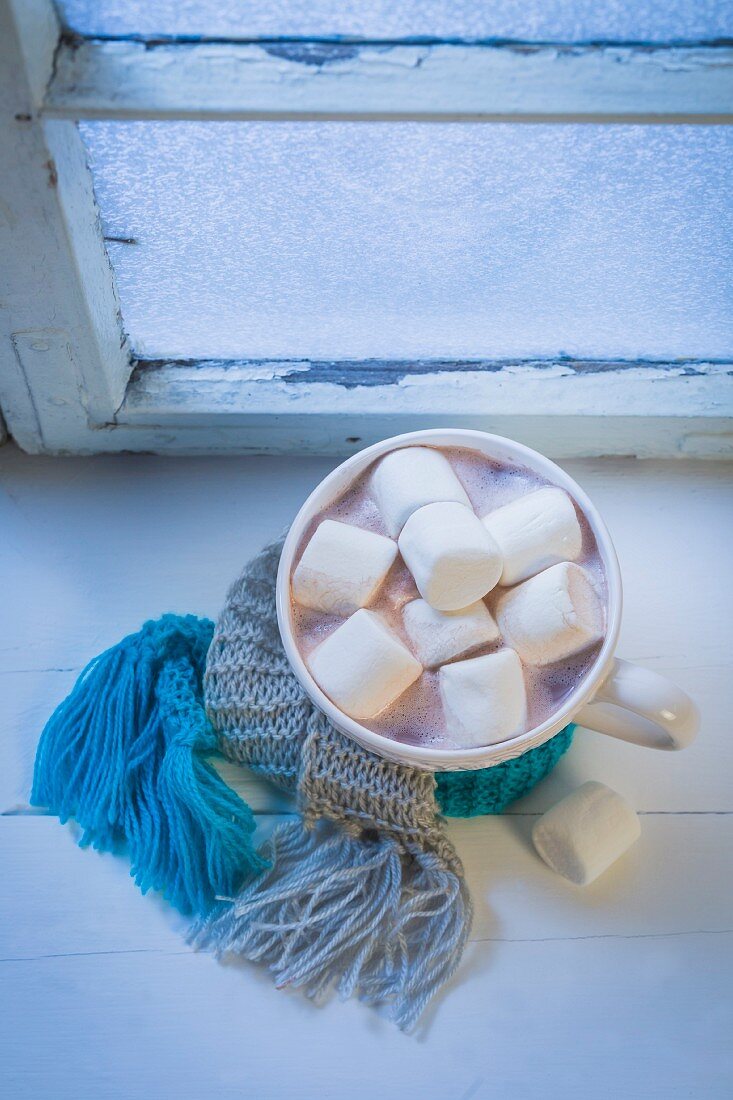 Hot chocolate with marshmallows on a windowsill