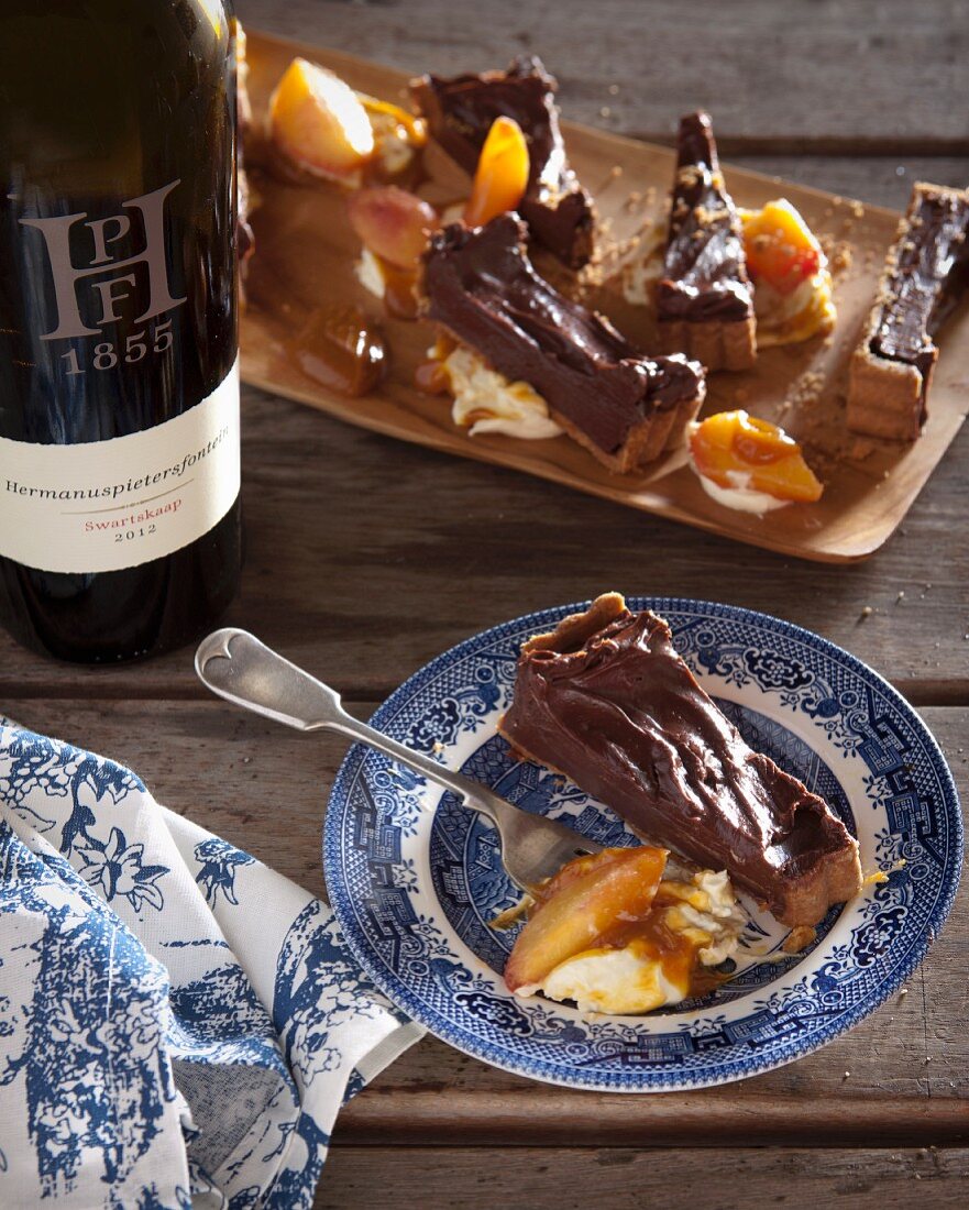 Chocolate ganache tart with baked fruit and cream