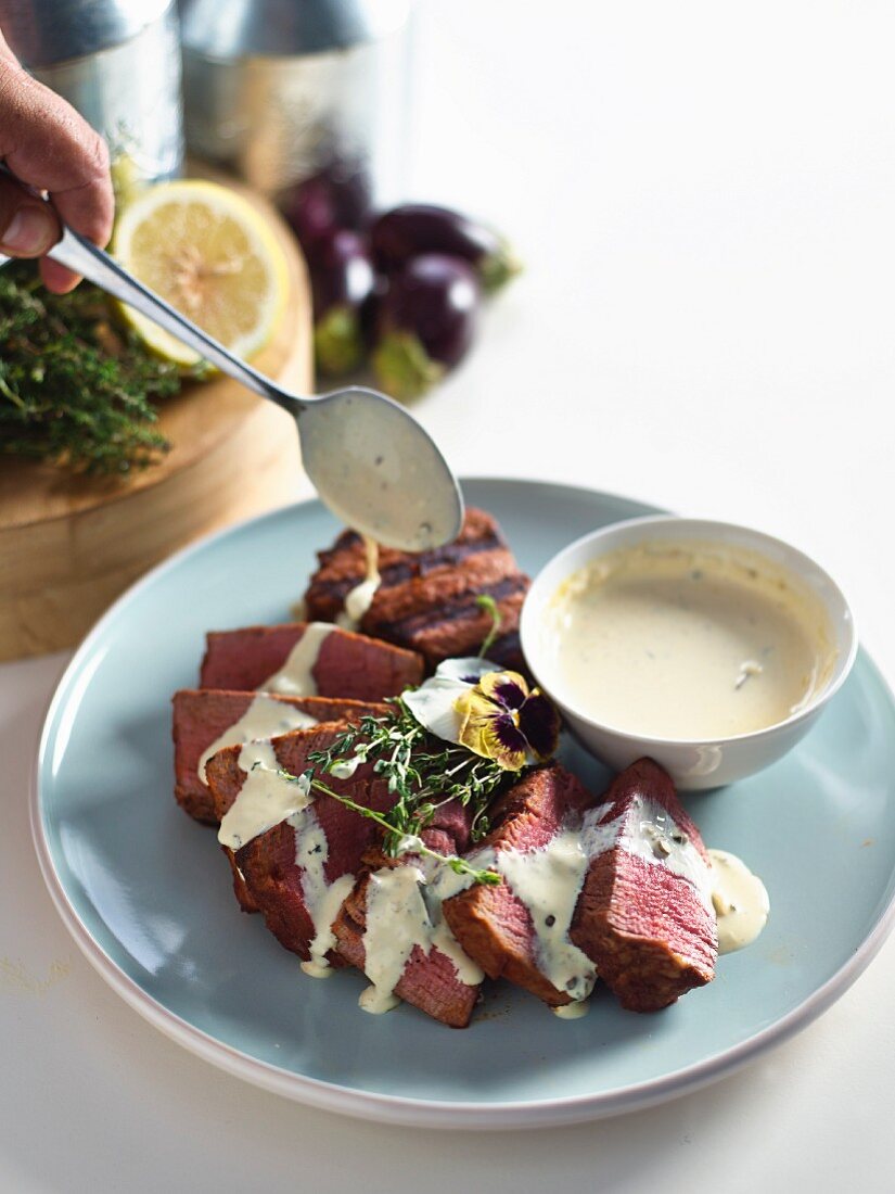 Grilled beef medallions with pink peppercorns, Cognac and bay leaf sauce