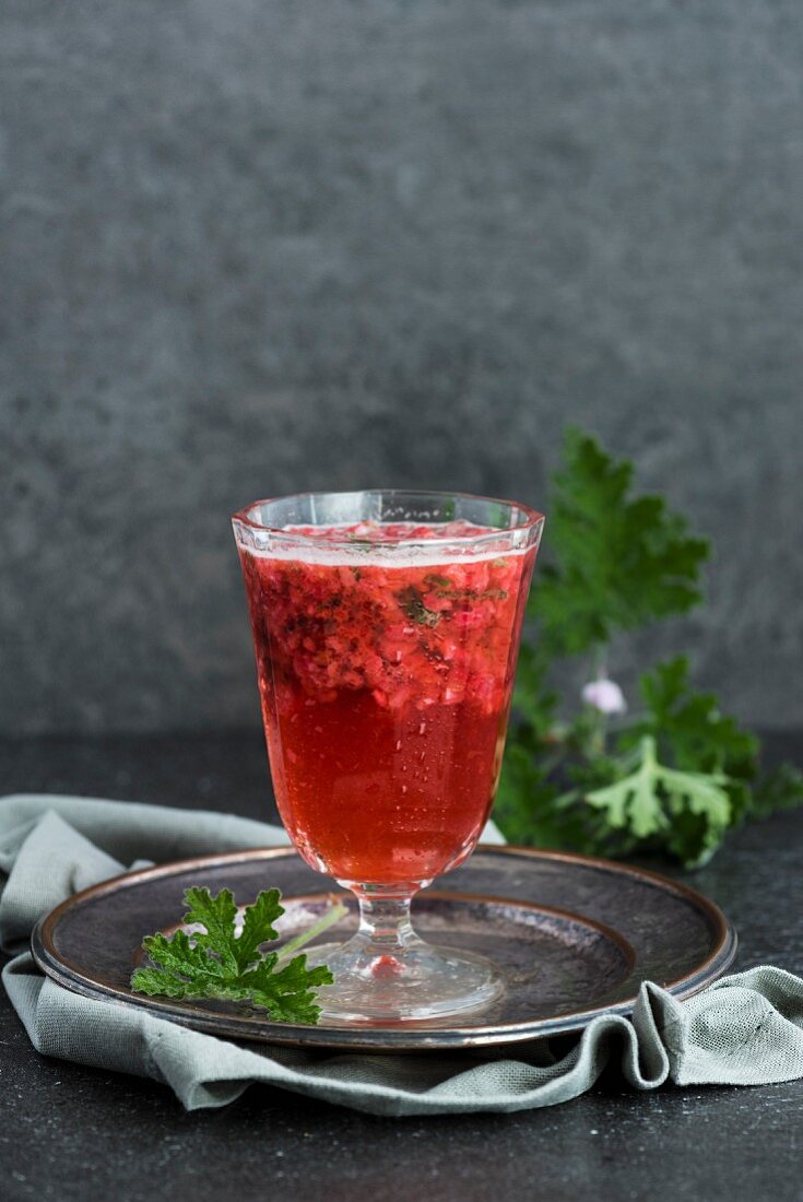 A beer cocktail with raspberries and scented pelargonium
