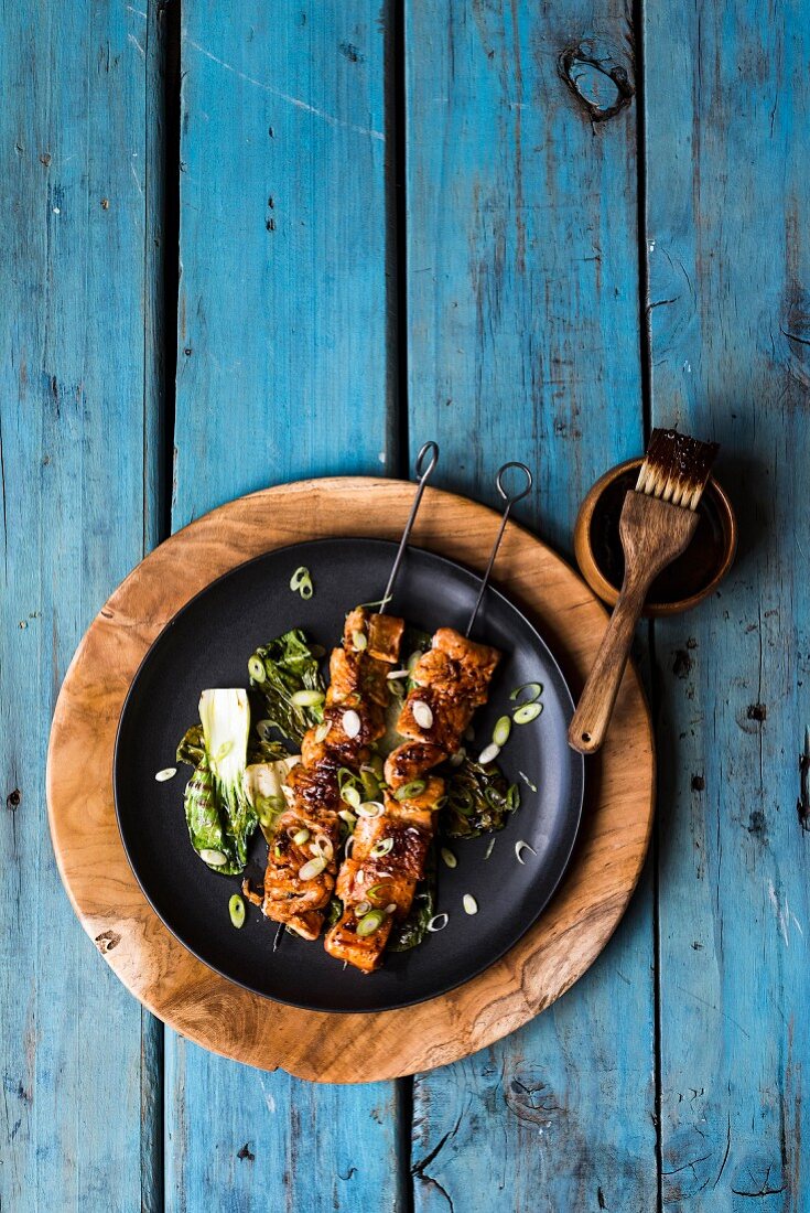Glazed trout kebabs on a bed of pak choi