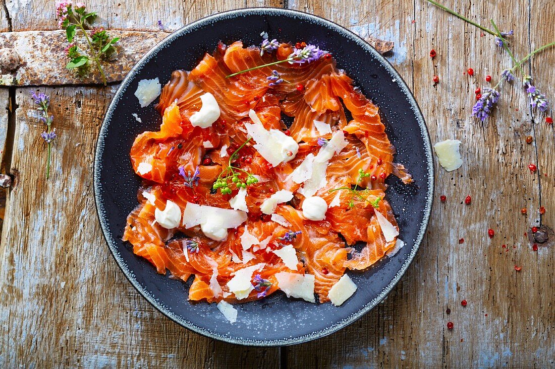 Salmon carpaccio with Parmesan shavings and red peppercorns