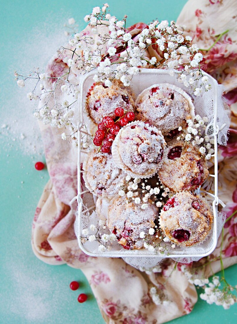 Cream cheese muffins with red berries in a white basket
