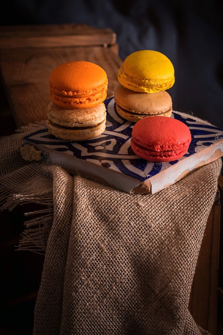 French macarons on a wooden table with sackcloth