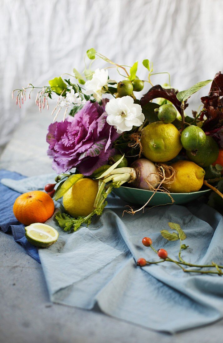 Arrangement of flowers, branches, fruit and vegetables