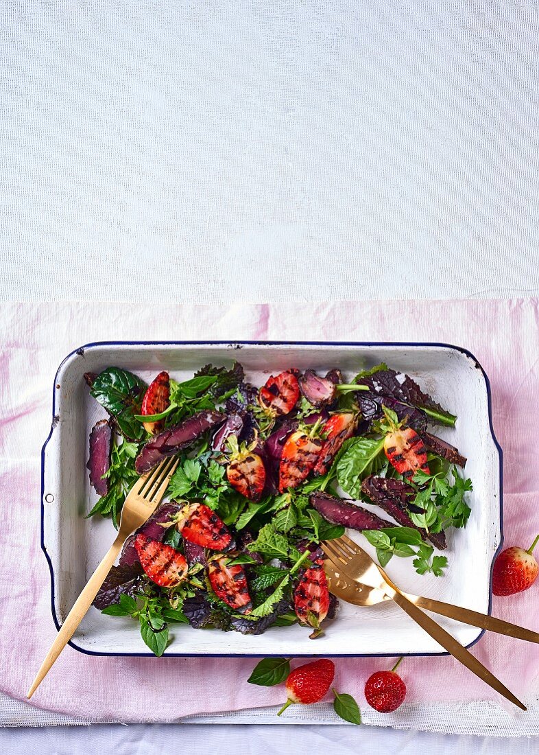 A leaf salad with biltong and grilled strawberries