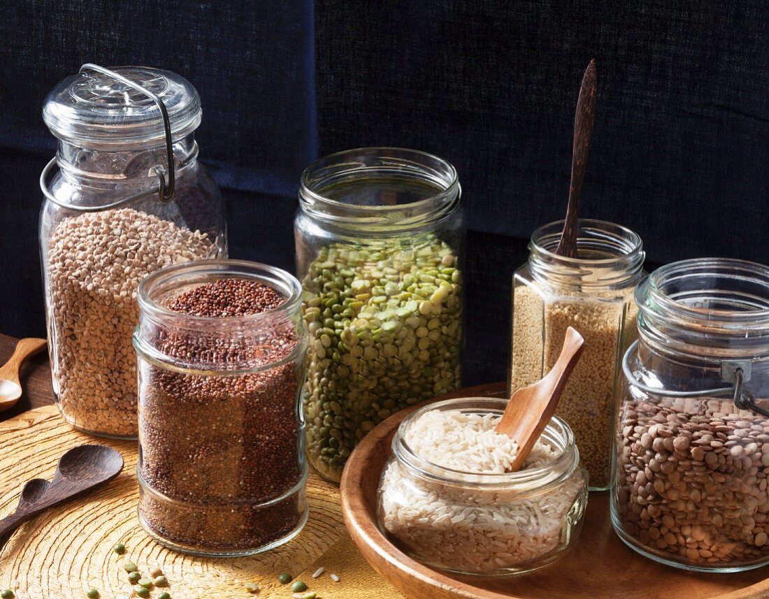 Lentils, rice, couscous, split peas, kasha, and red quinoa in preserving jars