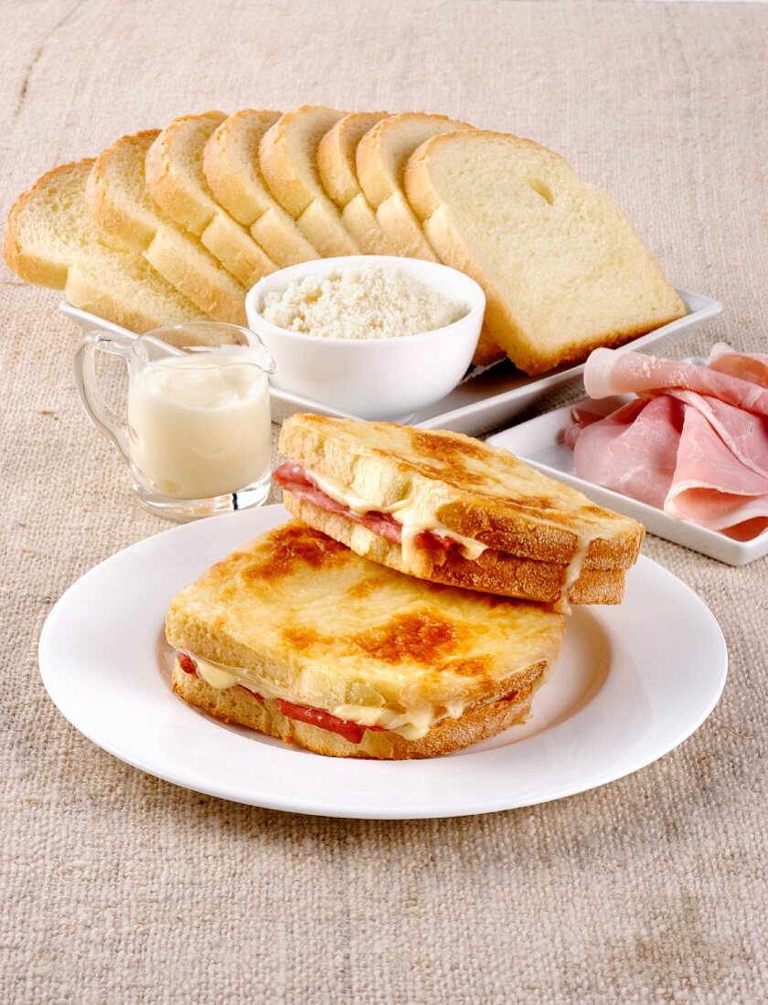 Toasted ham sandwiches covered in bechamel sauce