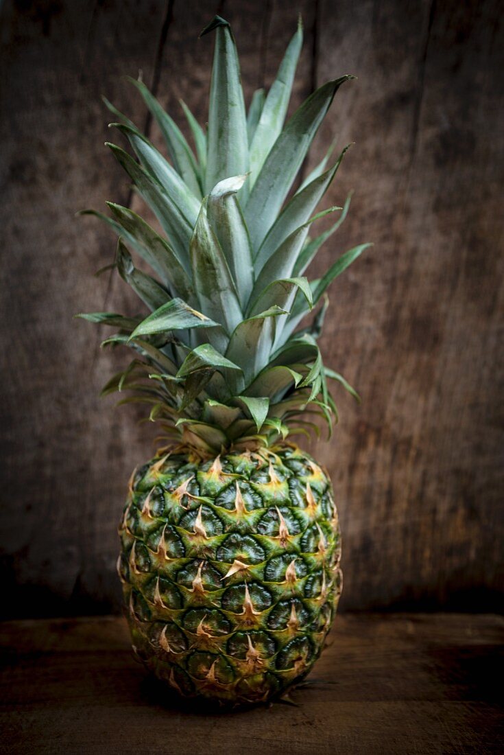 A pineapple on a wooden surface