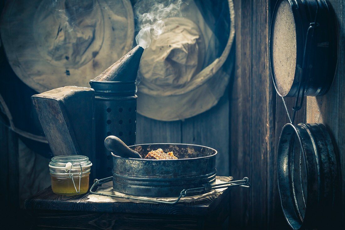 Old beekeeper's tools with honey