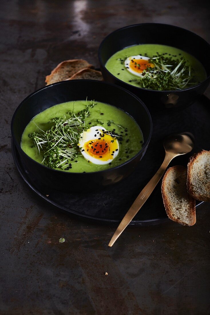 Pea soup with soft-boiled egg, cress and black sesame seeds