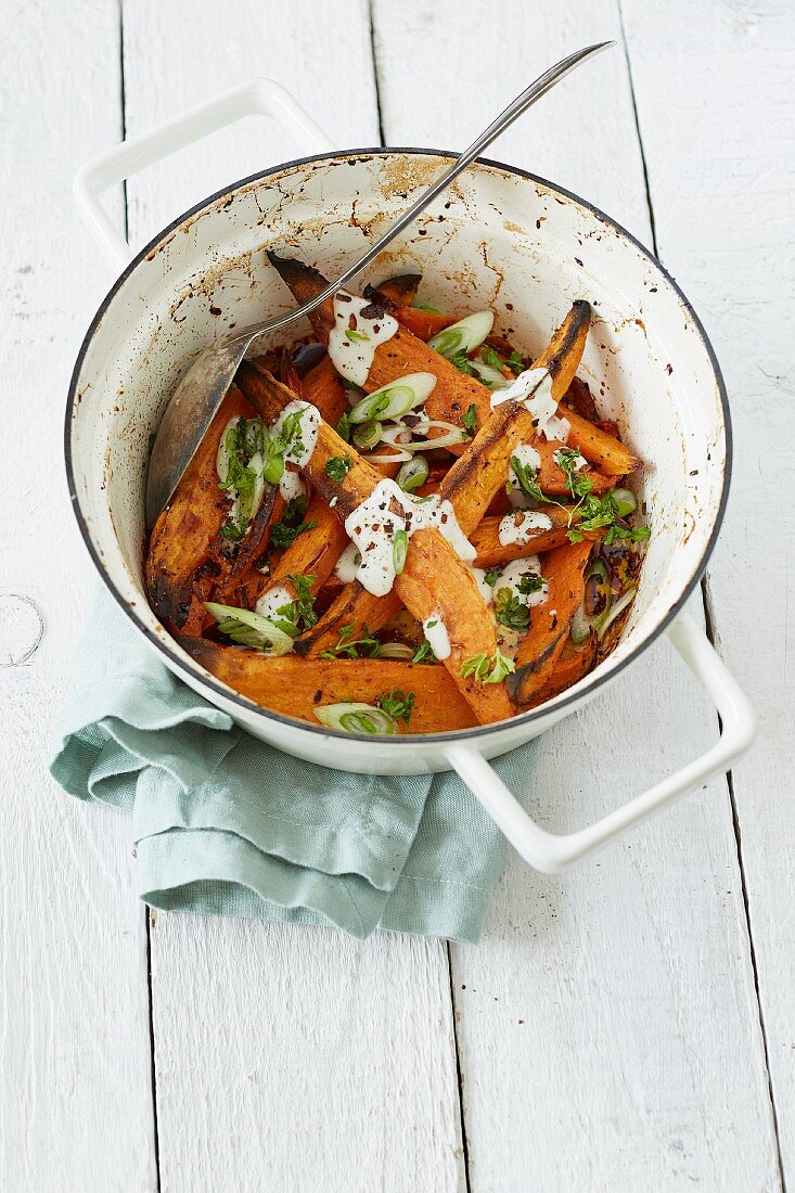 Roasted sweet potatoes with lime yoghurt and spring onions