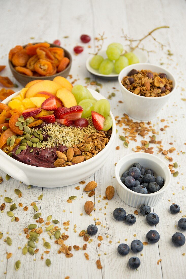 A smoothie bowl with acai berries, almonds and fruits