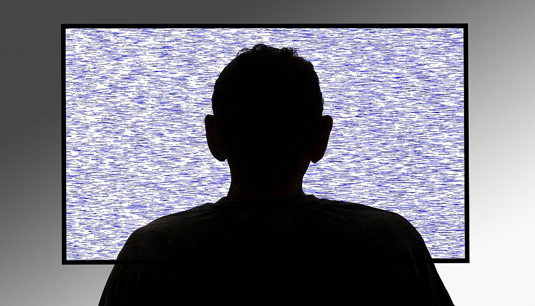 Person in front of flickering tv screen