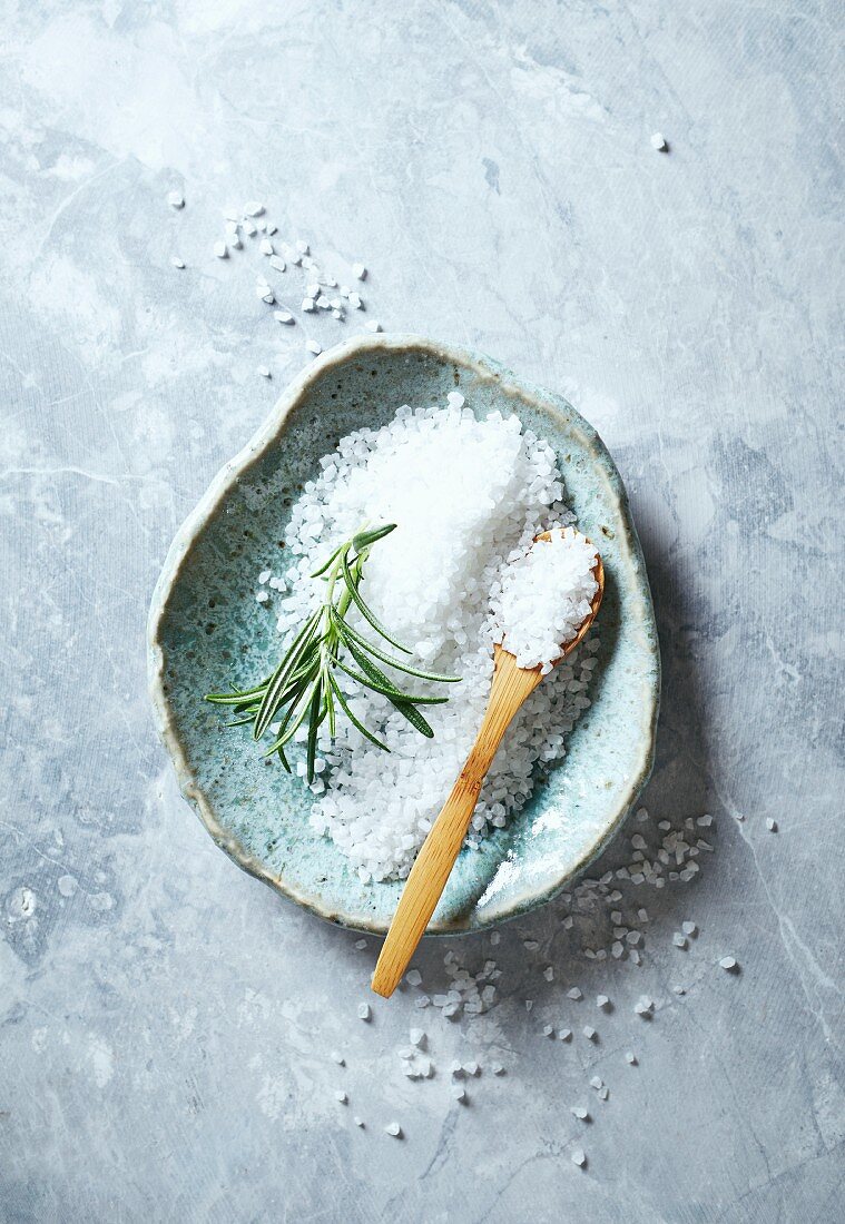 Natural bath salt with a sprig of rosemary