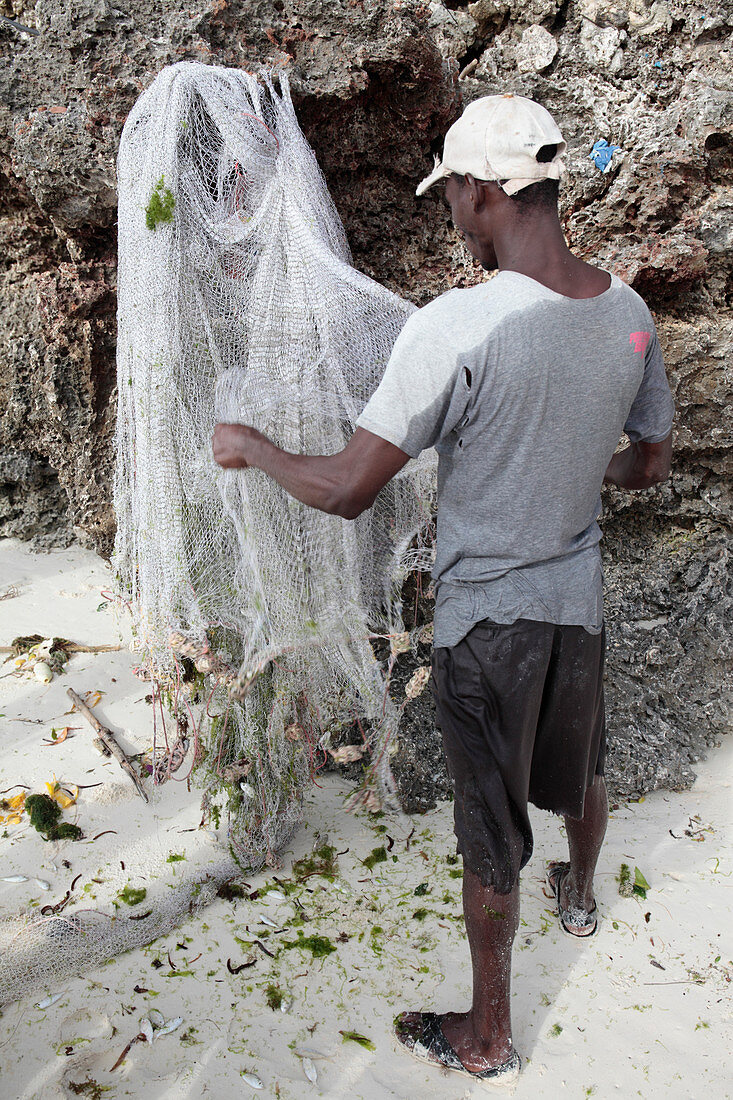 Fisherman removing fish from a net