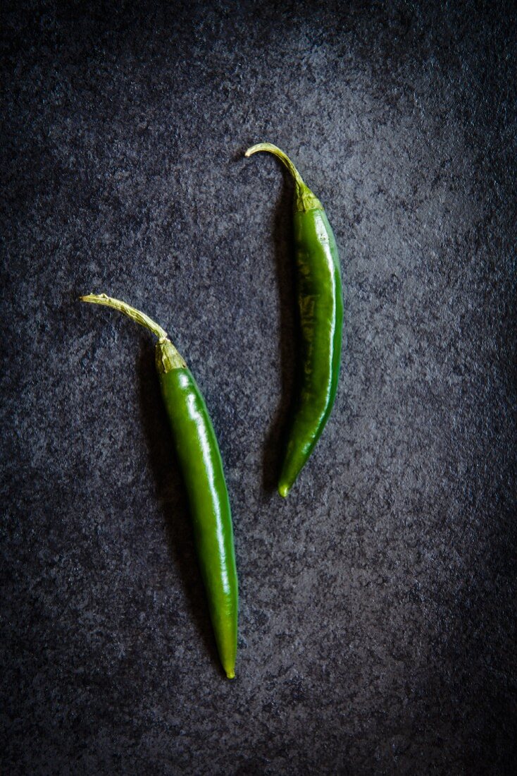 Two green chilli peppers (seen from above)