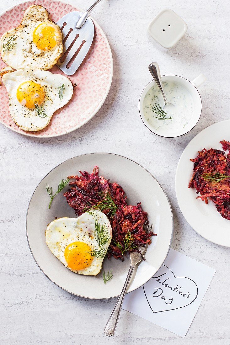 Beetroot and carrot fritters with heart-shaped fried eggs for Valentine's Day