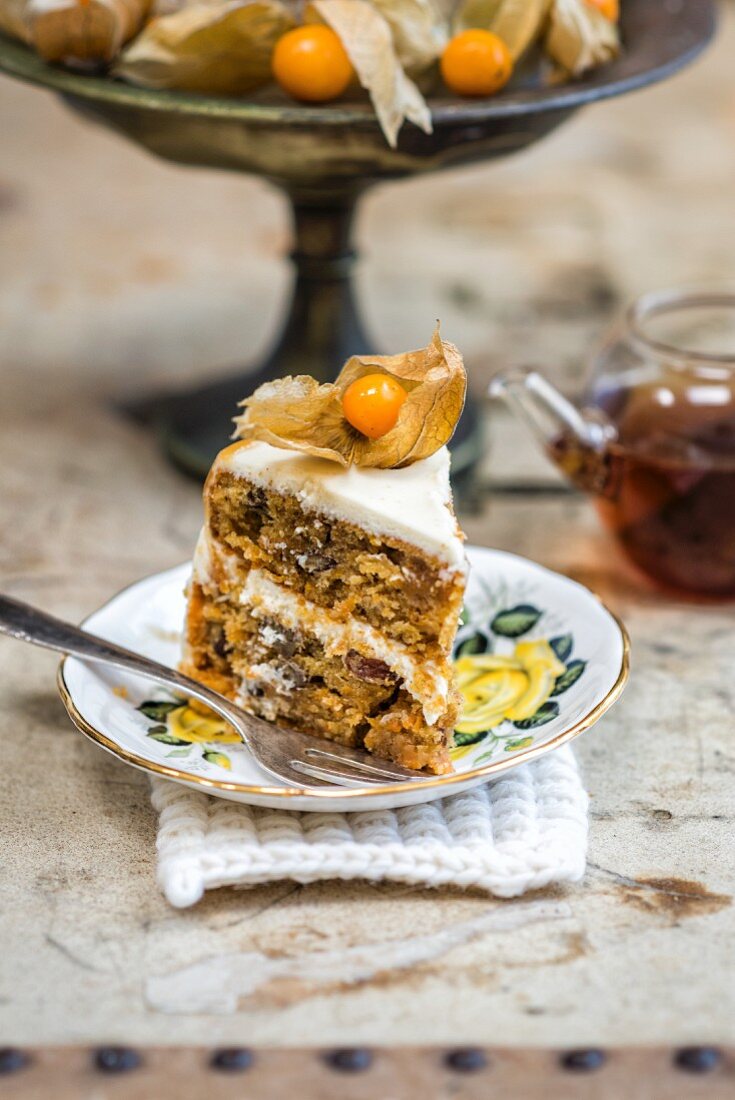 A slice of carrot layer cake with mascarpone icing and chai caramel
