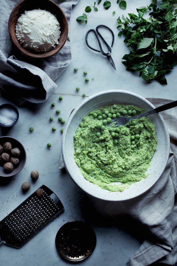 Ingredients for ravioli filling (pea purée, nutmeg, ricotta and herbs)