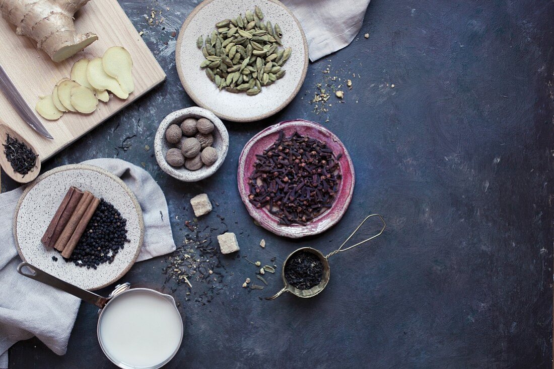 Ingredients for chai tea (milk, pepper, cinnamon, ginger, nutmeg and cardamom)