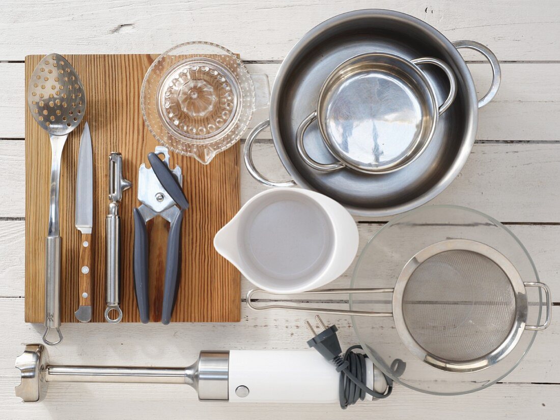 Kitchen utensils for the preparation of a vegetable salad with tuna sauce and a hard-boiled egg