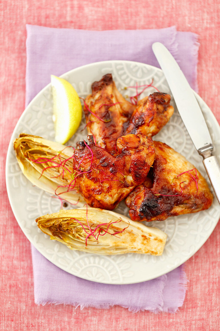 Grilled chicken wings with baked chicory