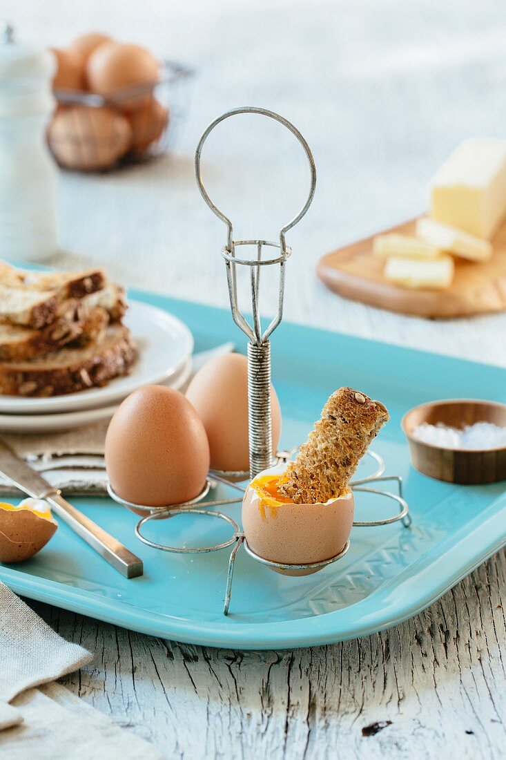 Soft-boiled eggs with toast in an egg rack