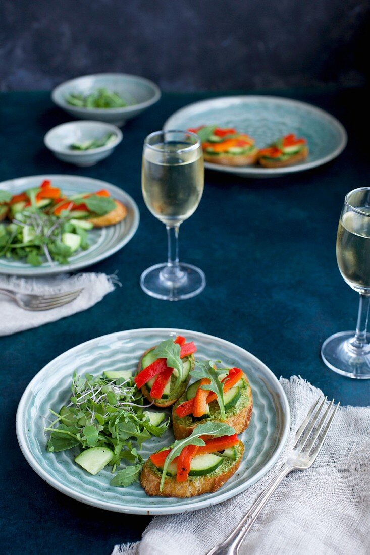 Chive crostini with cucumber, roasted red pepper and rocket