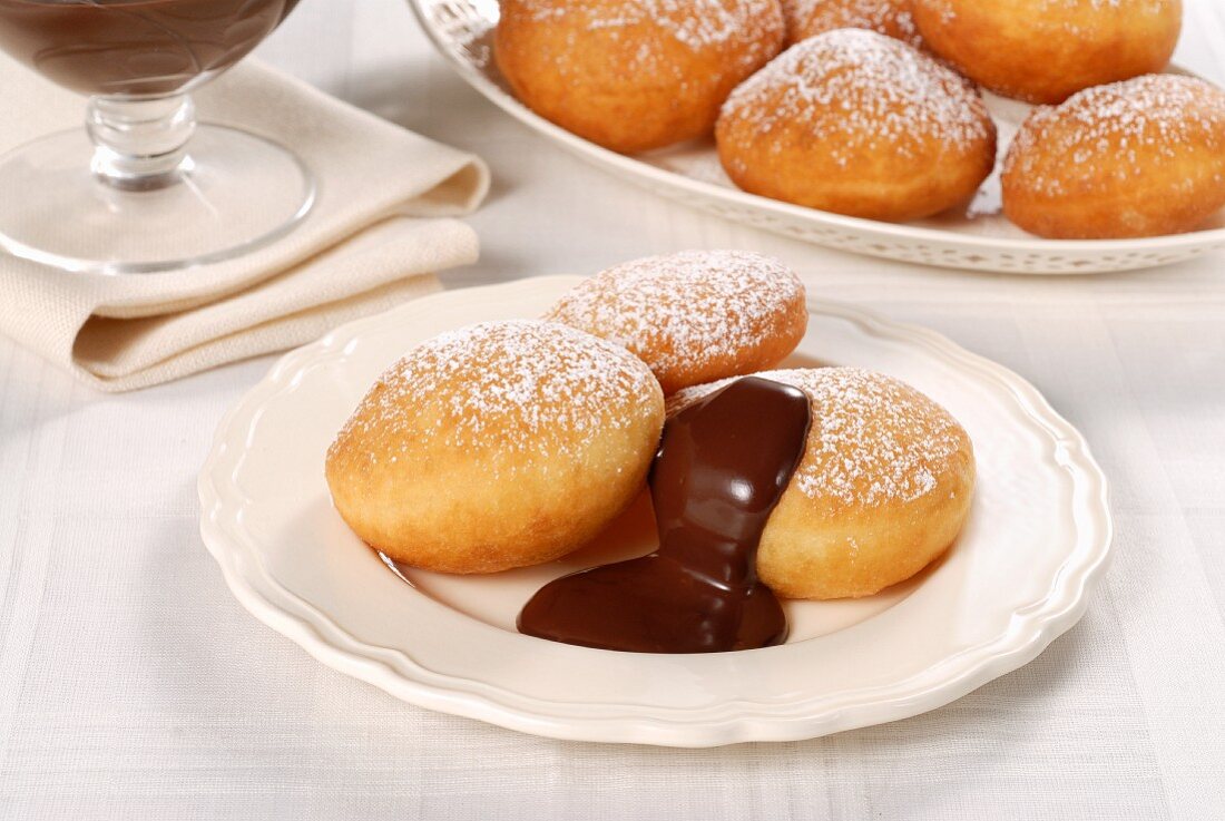 Bomboloni (Italian doughnuts) with chocolate sauce