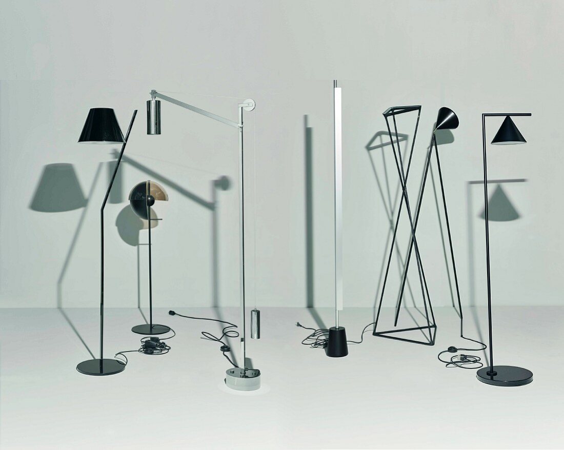 Various designer floor lamps casting shadows